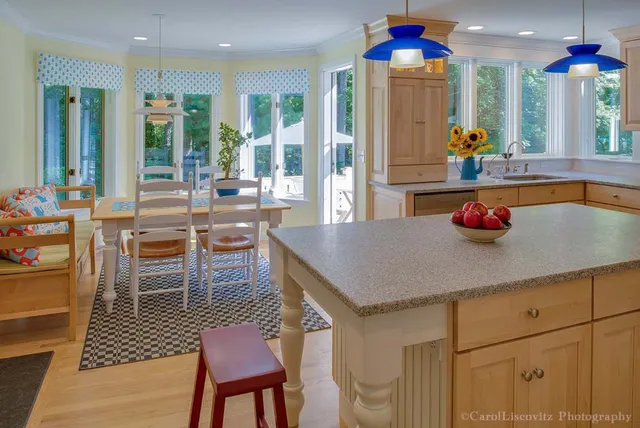 A kitchen with a table and chairs in it