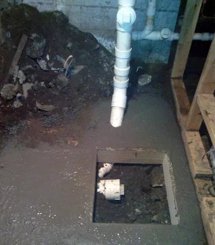 Fresh concrete patch over a relocated underslab drain