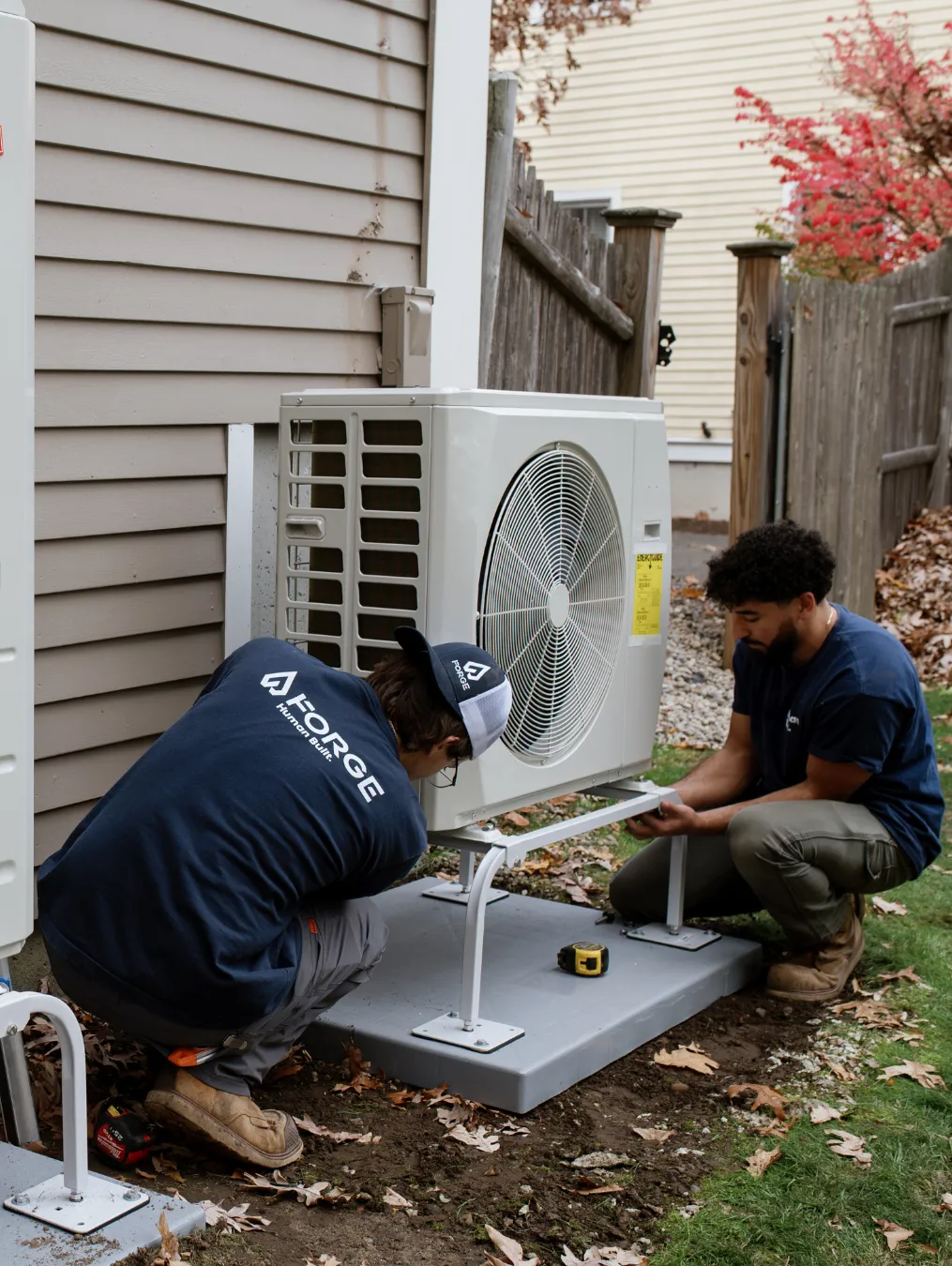 Forge HVAC tech servicing an outdoor condenser
