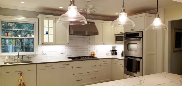 A kitchen with white cabinets and stainless steel appliances