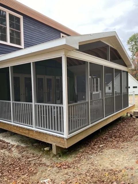 After: the finished screened porch with a gable roof and railings