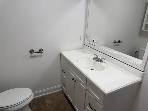 A bathroom with a sanitised tub and mopped floor