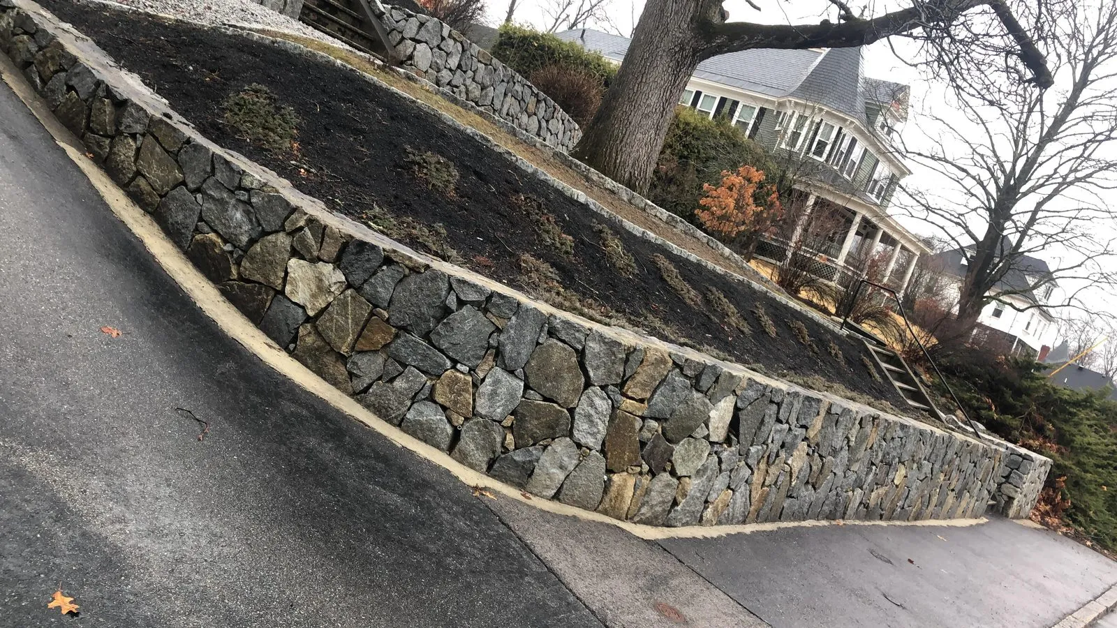 Long retaining wall along driveway