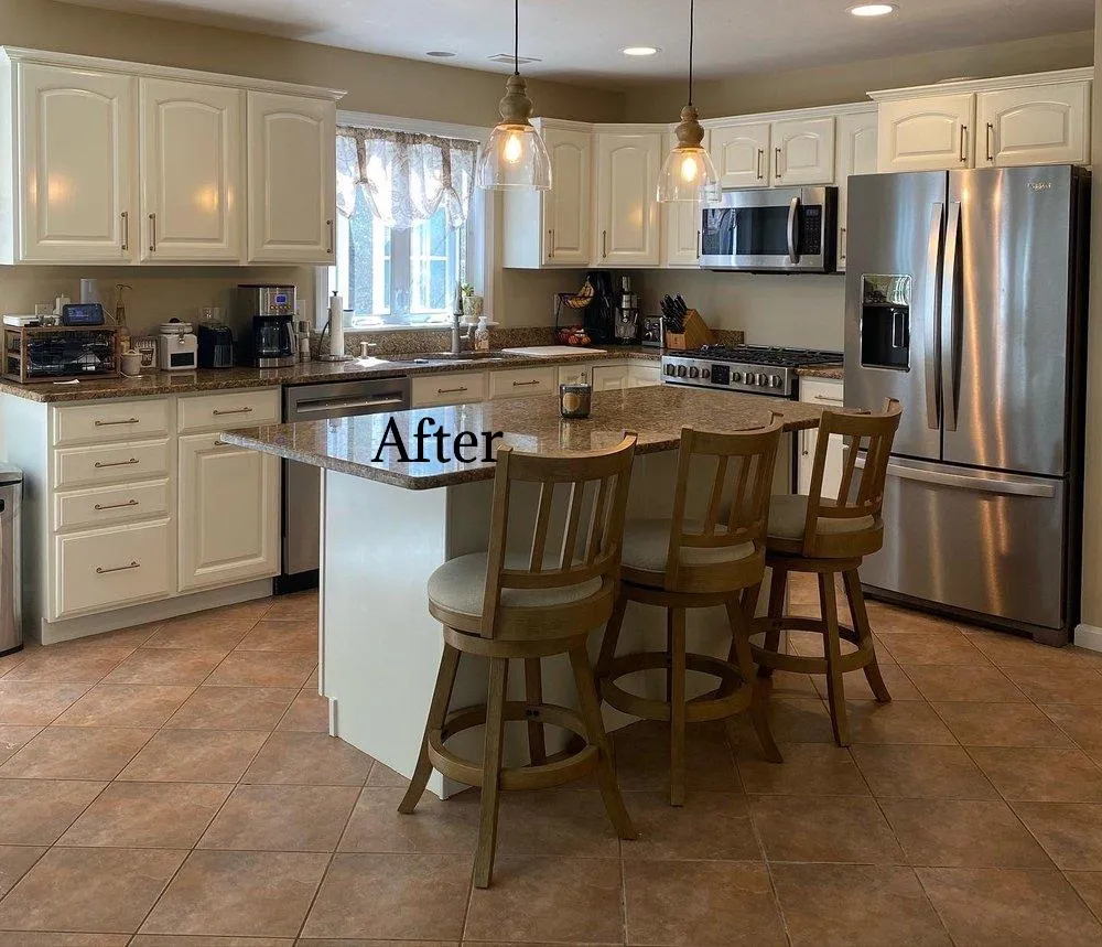 A beautifully updated kitchen with fresh white cabinets, brightening the space and making it pop with a clean, modern look by Impeccable Painting.