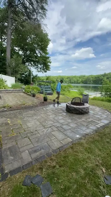 Cleaning a lakeside paver patio with a fire pit