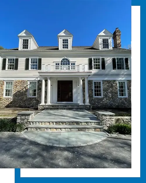 Residential home with completed stone driveway and landscaping