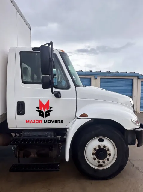 Major Movers truck parked beside storage units