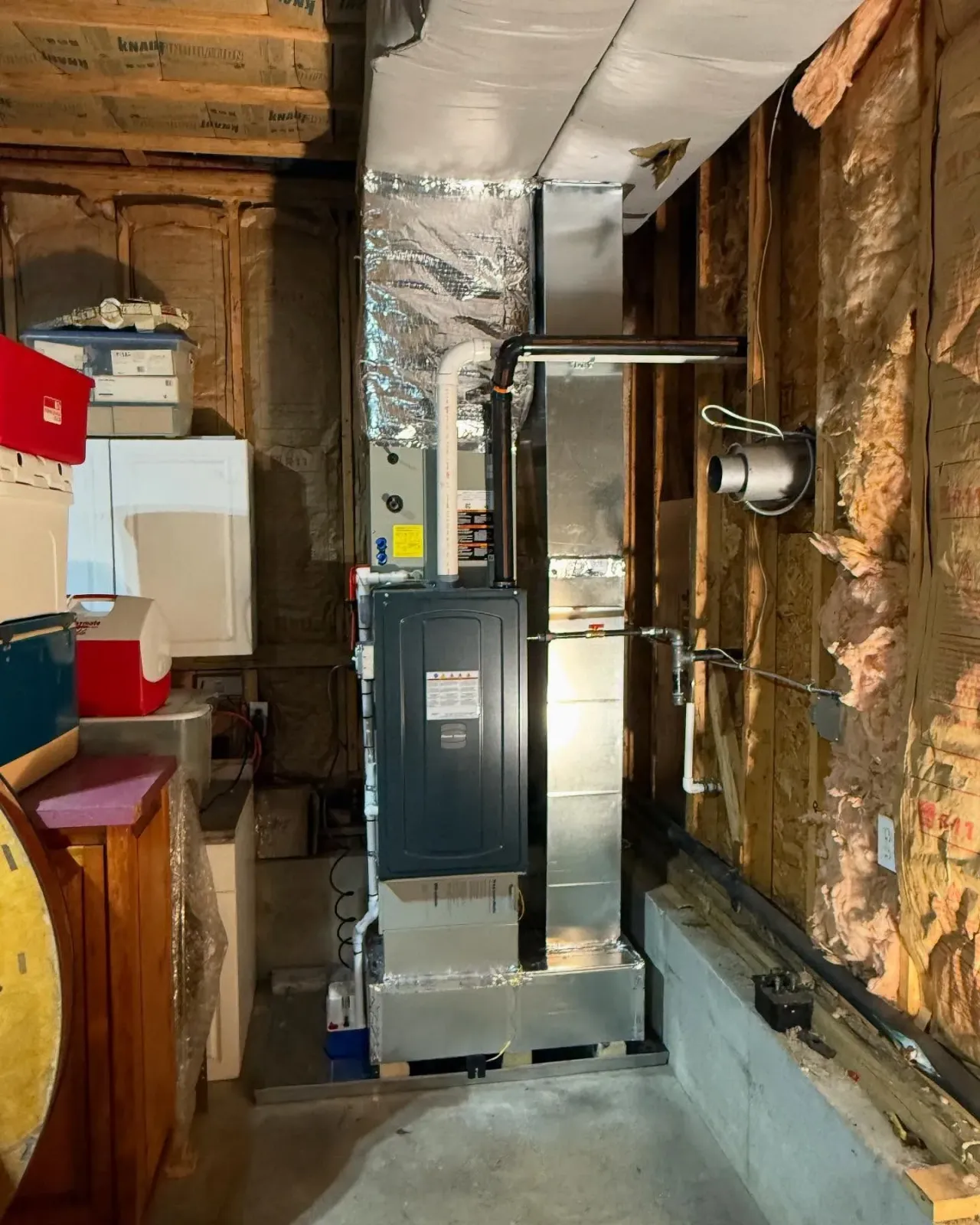 A room with a stove and a heater in it.