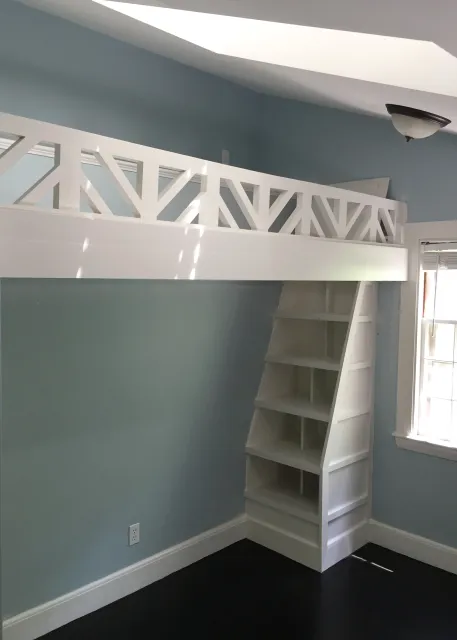 A whimsical playspace loft with trap door and bookcase "ladder" created for a girl's bedroom.