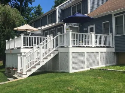 backyard deck with white railing and fence installation in Trumbull CT