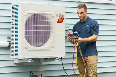 Mitsubishi air conditioner installed on home exterior wall for efficient cooling.