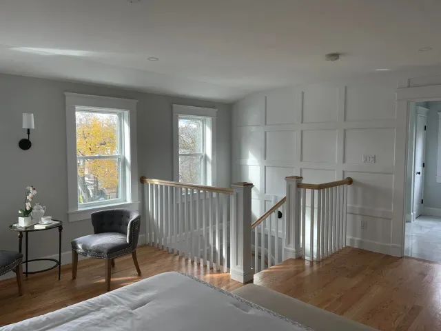 Upstairs landing with fitted wall panels around the stair opening
