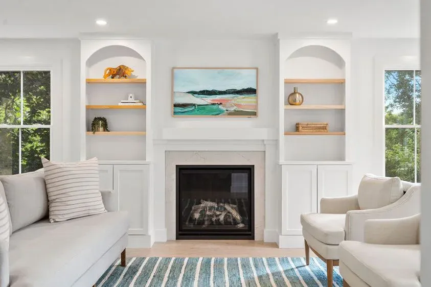 Painted living room with built-ins and fireplace
