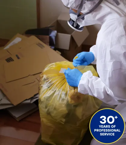 Aftermath worker closing a trashbag