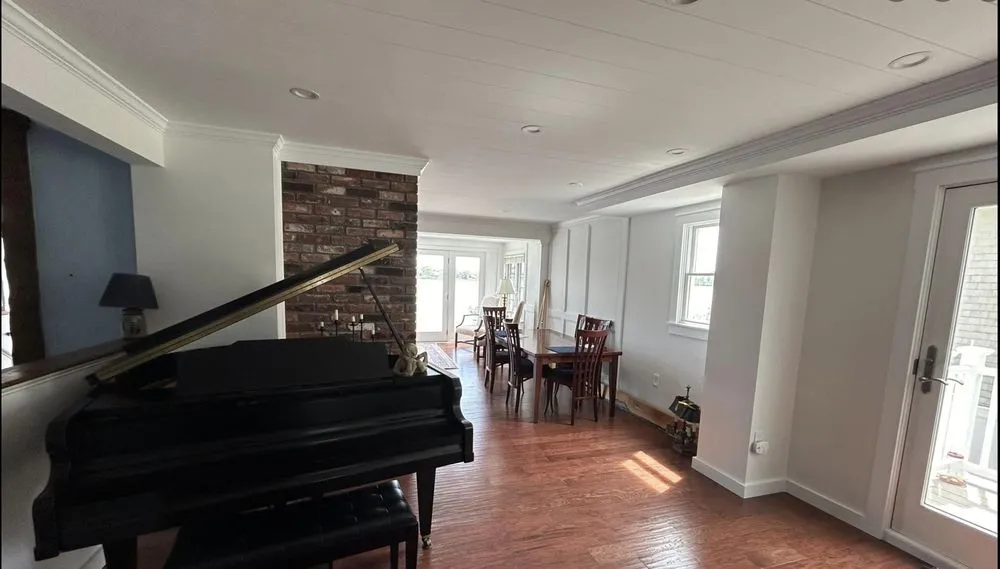 Open living and dining area with new recessed lighting