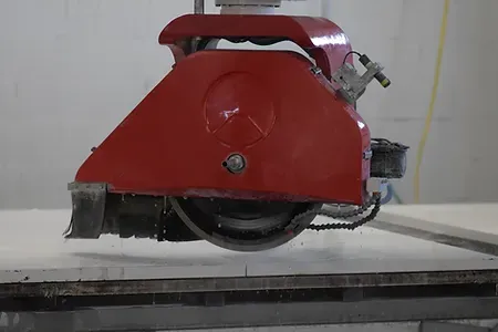 Stone saw cutting a slab inside Pioneer&rsquo;s Newington fabrication shop.