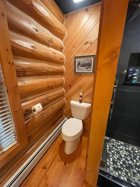 Log cabin bathroom cleaned by Brighter Days — lake house and camp cleaning Sebago Lake Maine