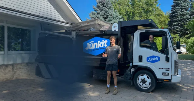 Junkit team and truck at a home in Charlotte Vermont providing full-service junk removal