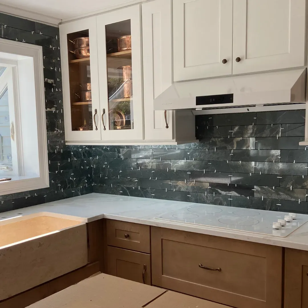 Custom kitchen with walnut cabinets, white range hood and dark green stone mosaic backs by SF Construction in Westborough, MA