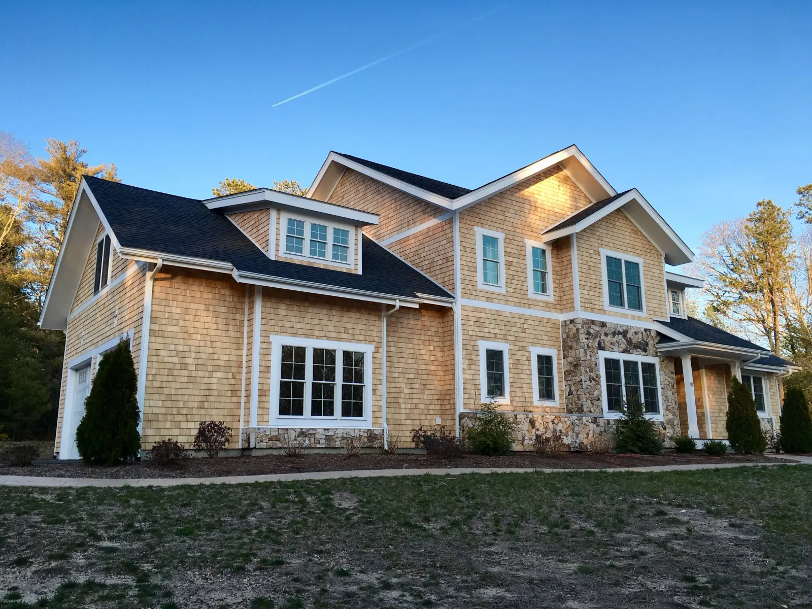 Newly renovated Cape Cod home with asphalt roofing, new cedar shingles, wood window and door trim complete from Fernandes Construction of Dennis.jpg