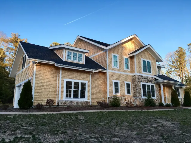 Newly renovated Cape Cod home with asphalt roofing, new cedar shingles, wood window and door trim complete from Fernandes Construction of Dennis.jpg