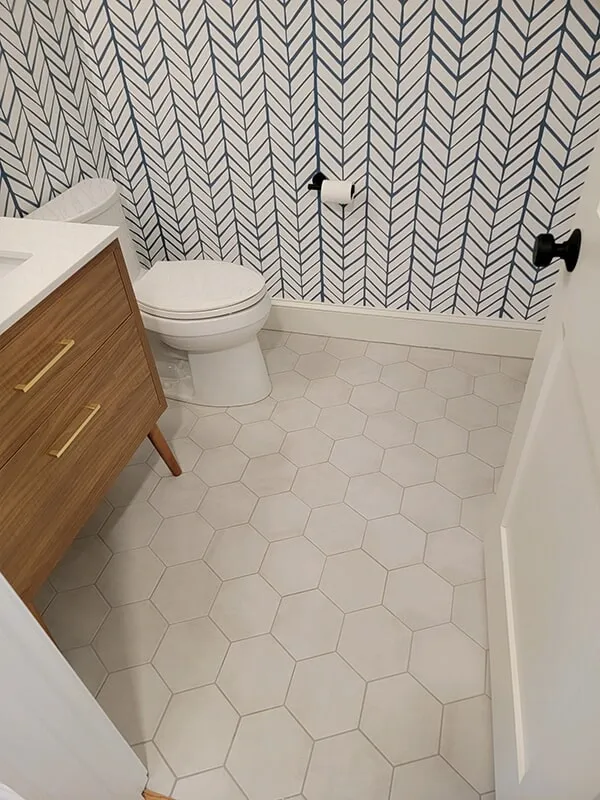 Bathroom with light geometric tile flooring in Ashland, MA