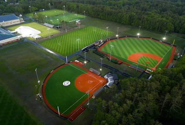 Aerial view of a vibrant, precision-crafted sports complex surrounded by nature.