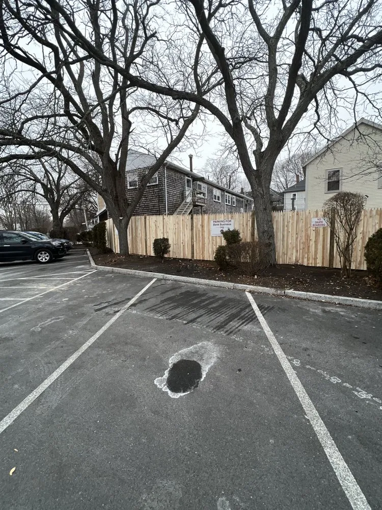 Finished cedar fence along a commercial parking lot