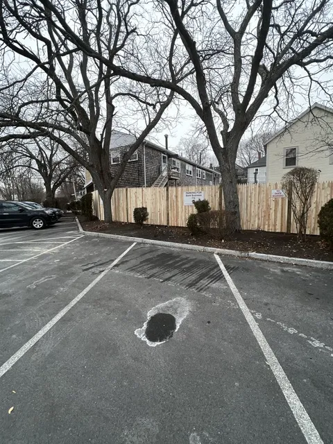 Finished cedar fence along a commercial parking lot