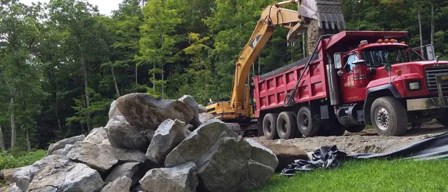Berkshire contractors site with red truck moving mountains