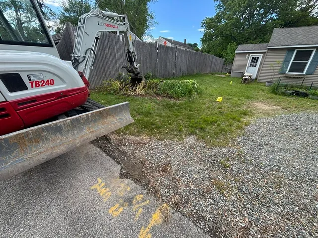 Compact excavator on a residential job site for excavating contractor Hampton, NH