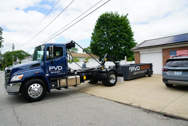 Roll-off dumpster delivered to a residential driveway