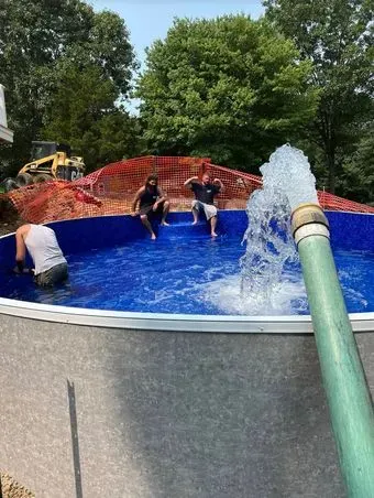 A group of people are sitting in a swimming pool.