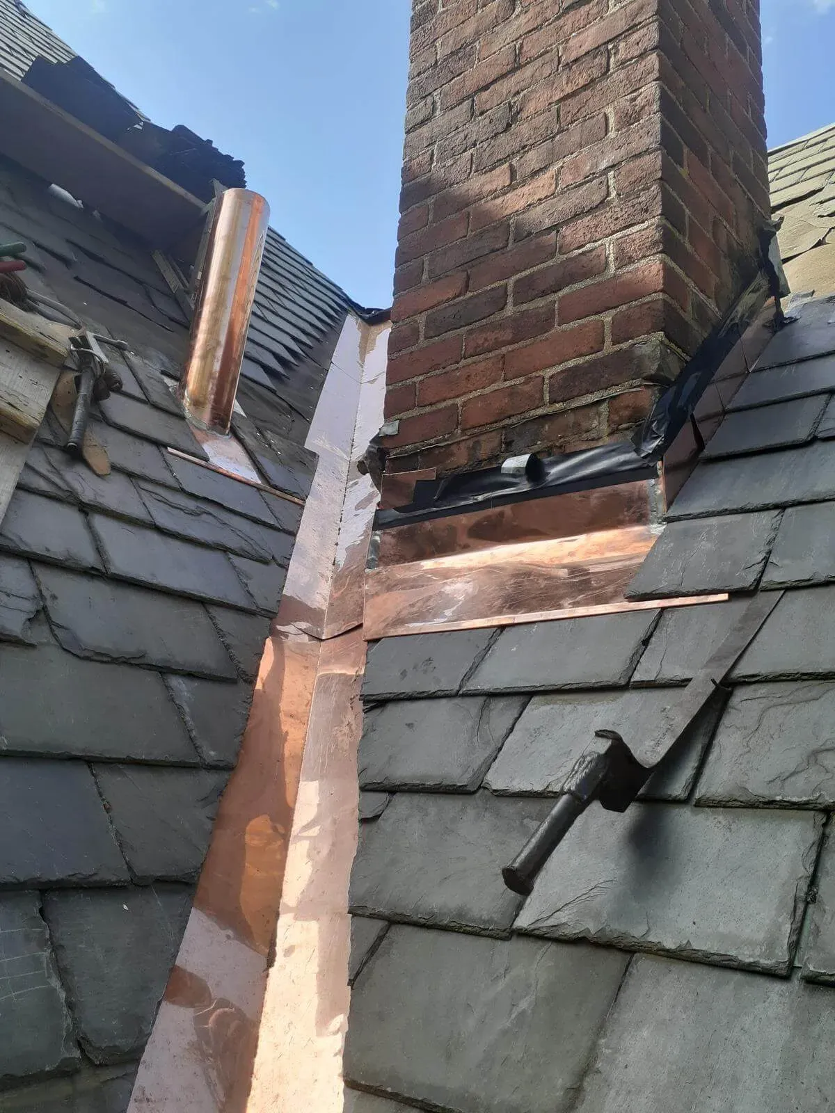A photo of USA Original Construction's handiwork in slate and copper roofing.