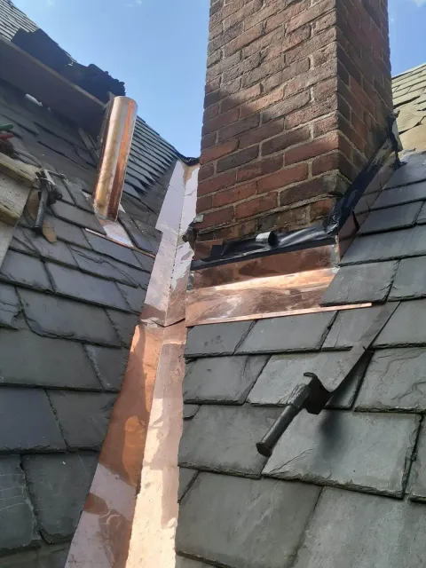 A photo of USA Original Construction's handiwork in slate and copper roofing.