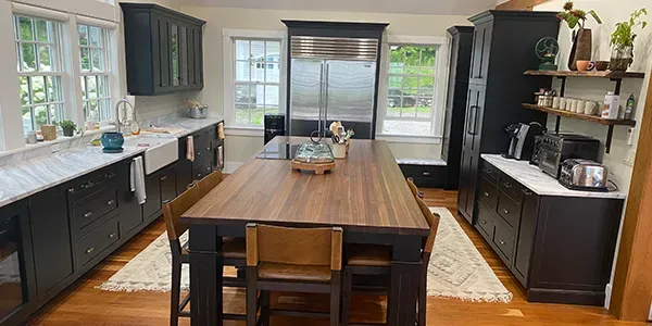 A kitchen with a large wooden table and chairs.