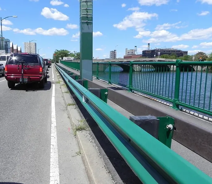 Highway guardrail installation on a bridge approach