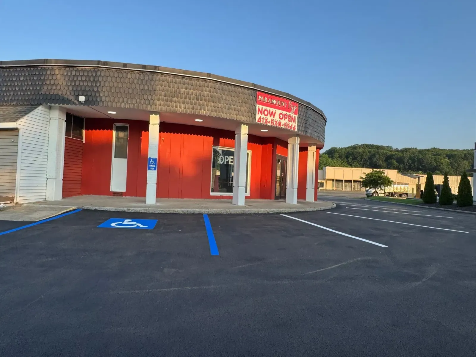 Exterior of a red and white building with a sign reading
