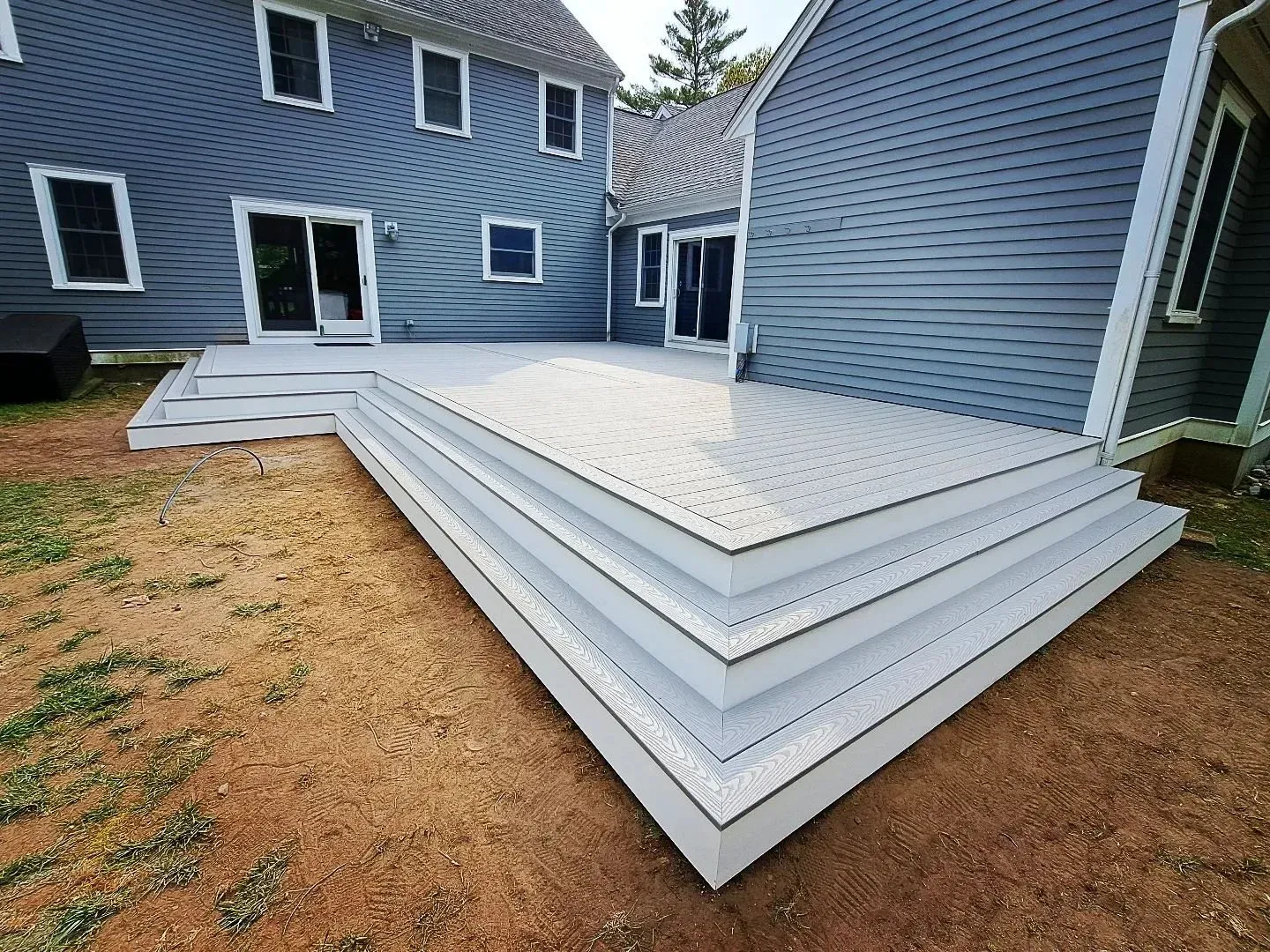 Composite deck with stairs Plymouth MA built by Freeland Woodworks general contractor.
