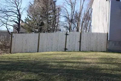 Cedar privacy fence with gate along a back yard