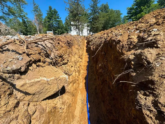Water line being laid in sand bed — 200-foot utility trench