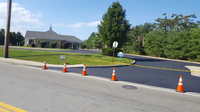 A street with cones and signs on the side of it.