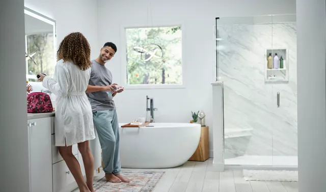 Man and woman getting ready in a beautiful bathrooom