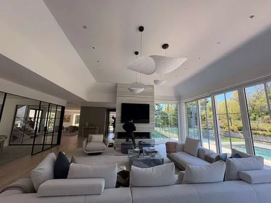 A stunning living room transformed by our recent professional interior painting, providing a durable, elegant finish to the walls and ceiling surrounding the fireplace.