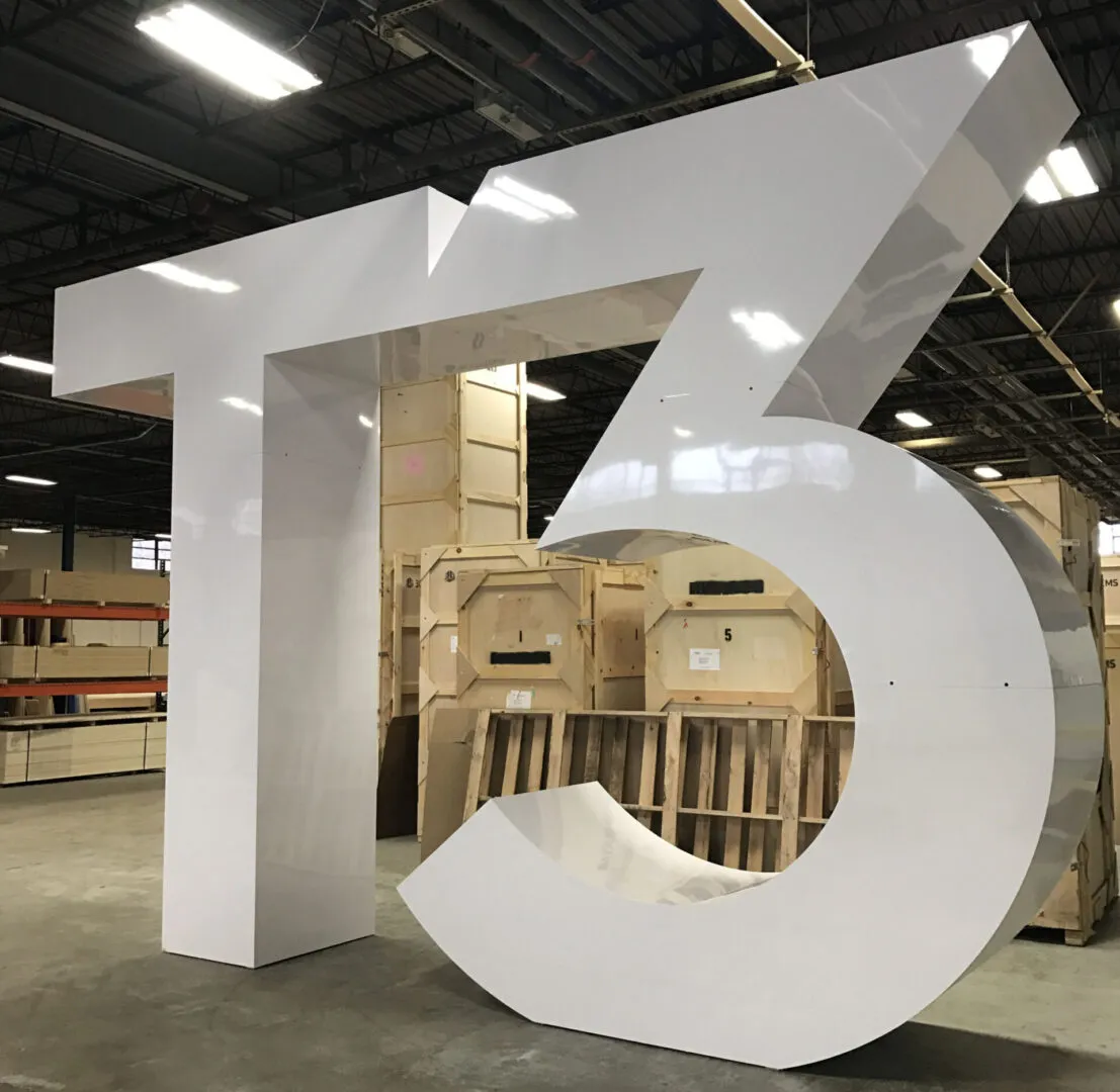 Large white T5 sculpture in warehouse