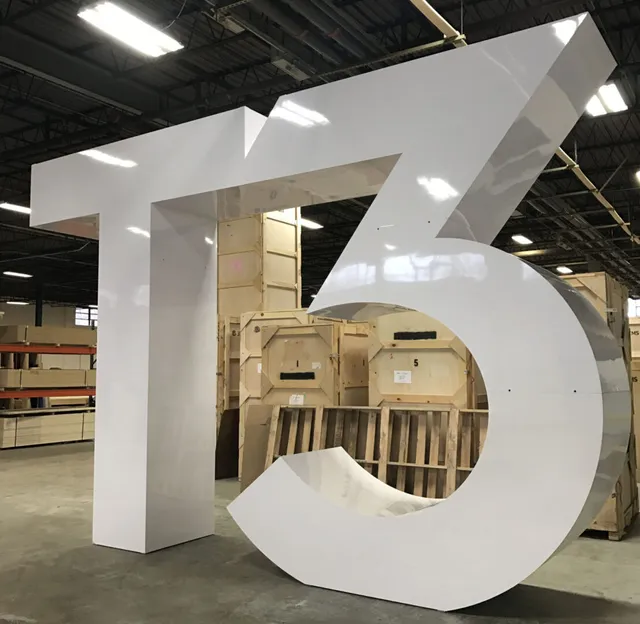 Large white T5 sculpture in warehouse