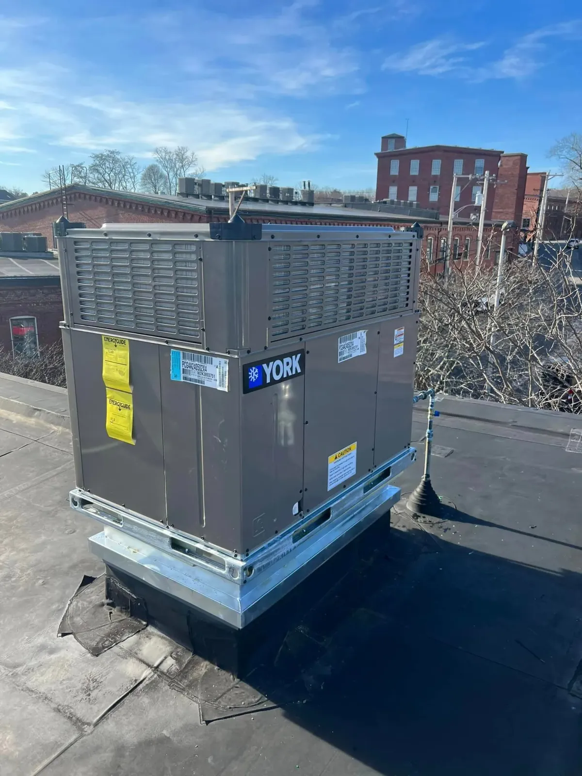 An air conditioner is sitting on the side of a house.