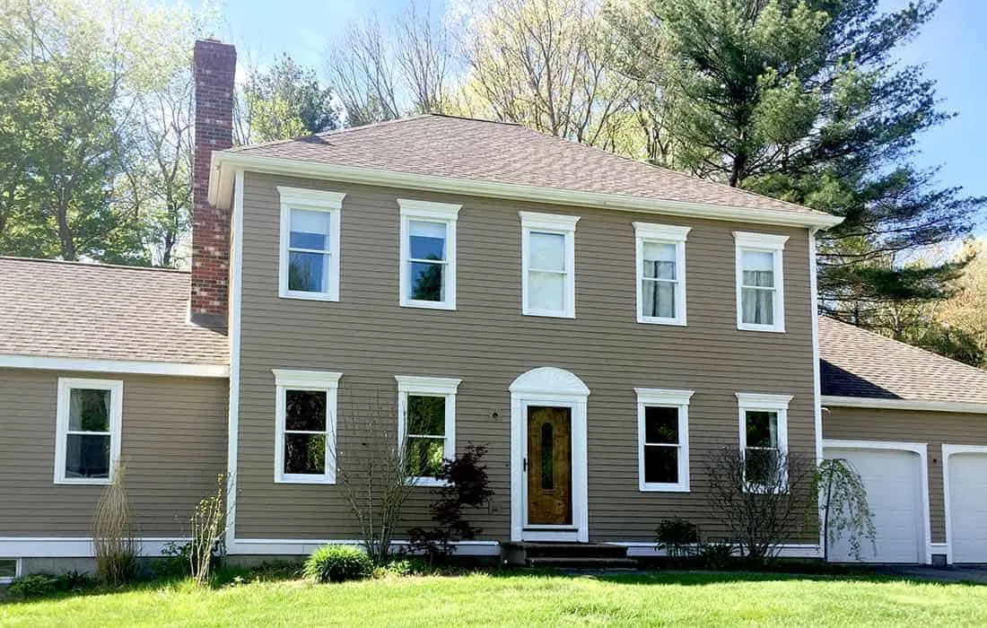 Front of home showing new matching picture windows and a wide inset entrance.