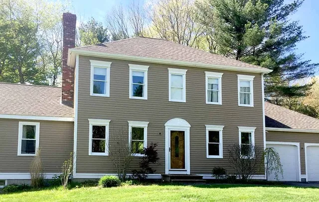 Front of home showing new matching picture windows and a wide inset entrance.