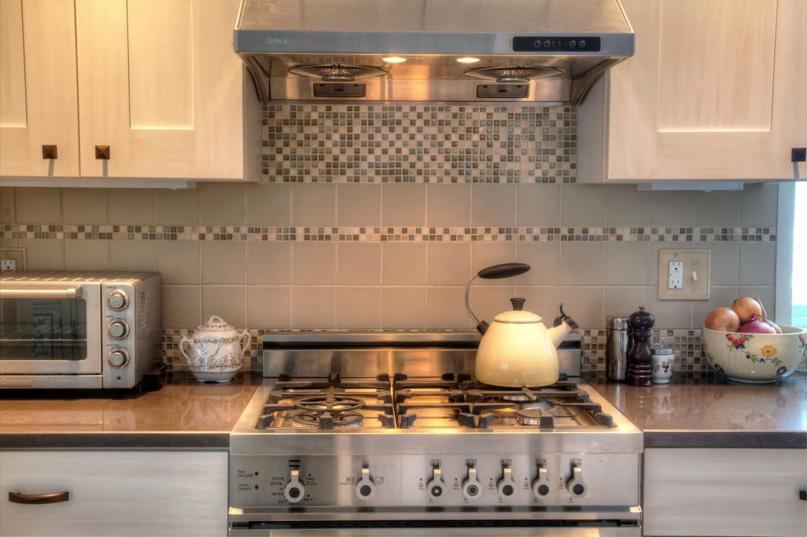 Finished kitchen with tile backsplash and gas range
